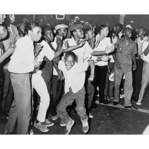 1964 photo Part of crowd in Harlem chants and taunts police on Lenox 