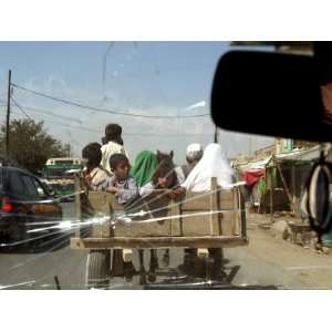  Afghans Sit in the Back of a Cart on the Outskirt of Kabul 