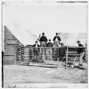    Civil War Reprint Soldier chopping wood in camp