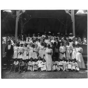  African American children with a few adults in a pavilion 