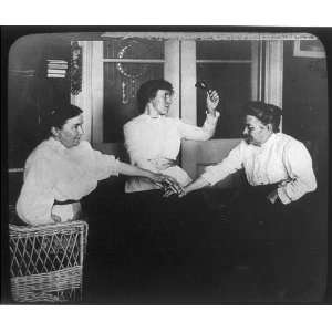 Seance,three women holding hands,table,spiritual,ghosts,holding bell 