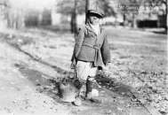1909 African American boy carrying bucket of coal  