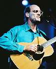 JAMES TAYLOR IN BLUE SHIRT PLAYING GUITAR IN CONCERT 24