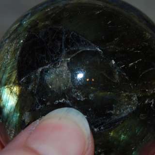 You are considering a beautiful labradorite sphere with a hematite 