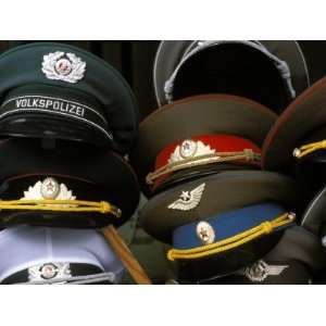 Pile of Communist Era Army and Police Hats for Sale as Souvenirs 